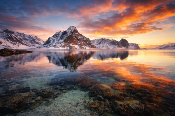 Berglandschap met besneeuwde bergen en reflectie in helder meer tijdens kleurrijke zonsondergang als luxe natuur wanddecoratie.